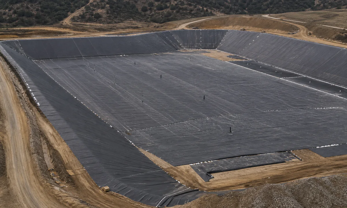 Elevated view of a generic geomembrane-lined containment cell under construction