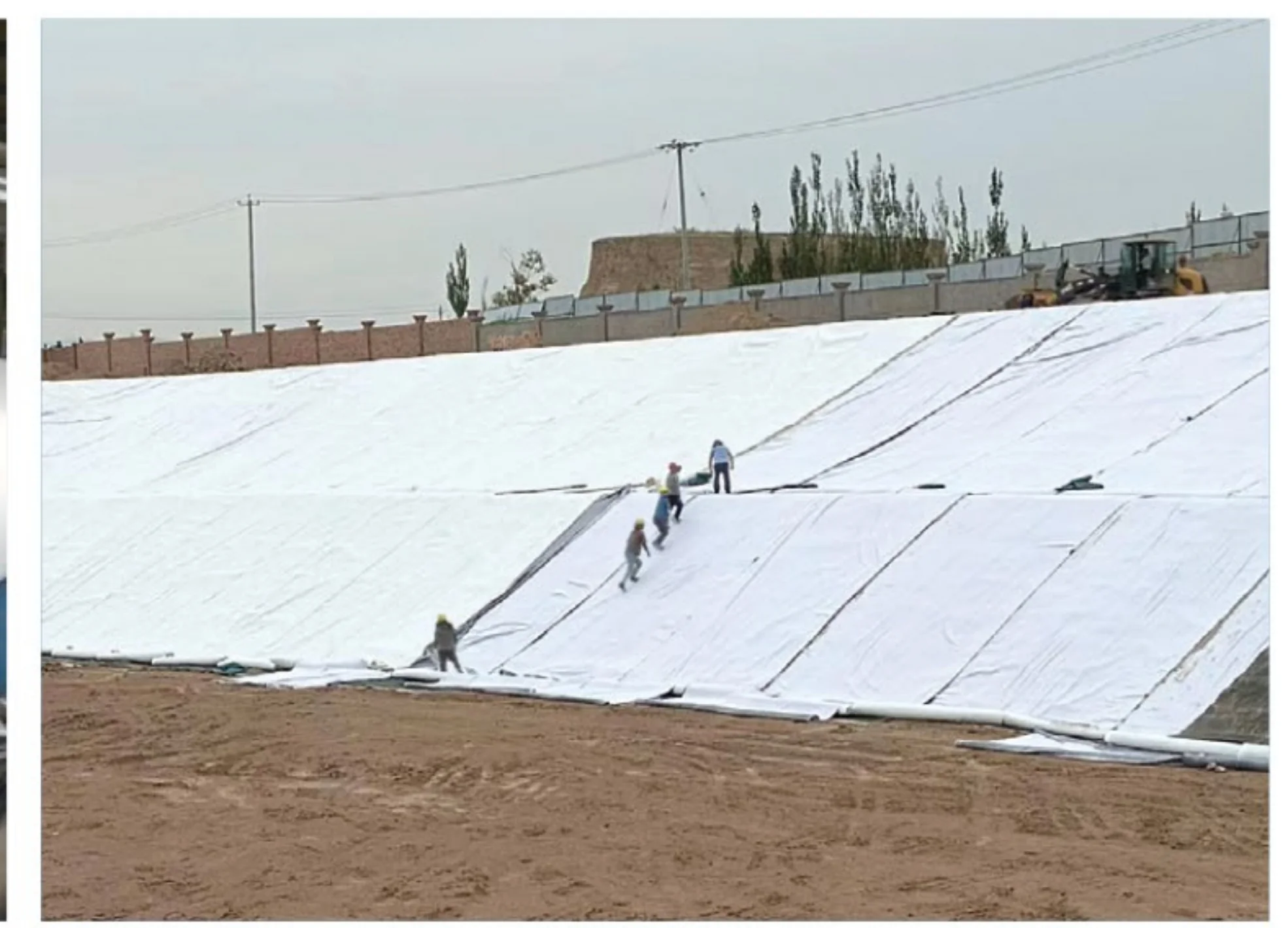 White geotextile material being placed across an engineered slope